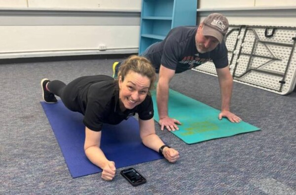 Kerry Ann Madden and her husband Damian holding planks