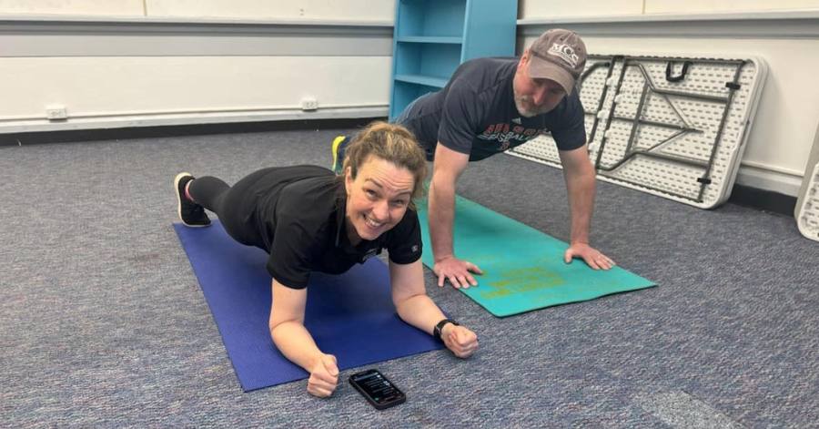 Kerry Ann Madden and her husband Damian holding planks