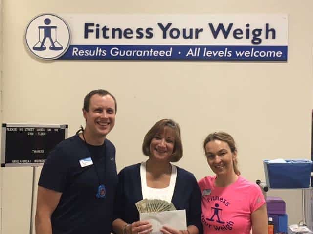 Fitness your way staff presenting Patty with proceeds from 4th annual plant-a-thon